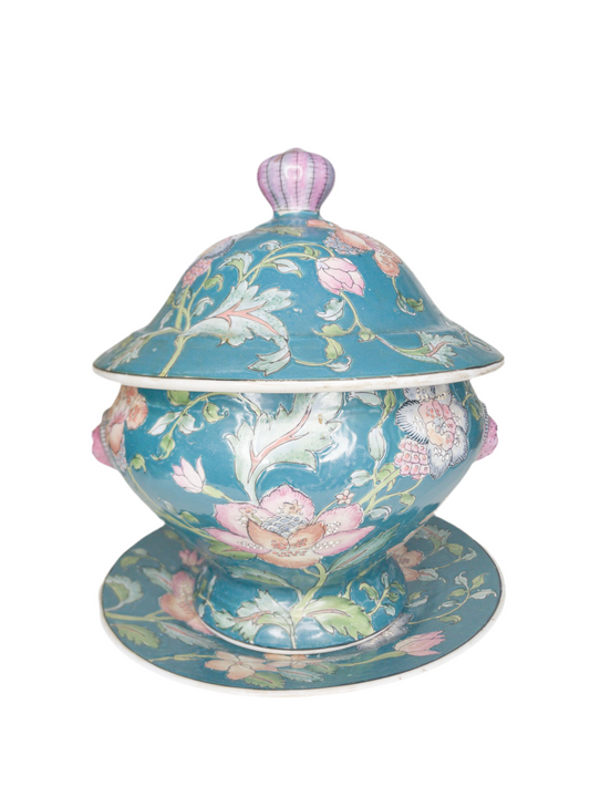 Decorative ceramic tureen with floral design on a white background