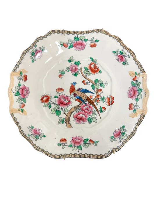 Decorative plate with floral and bird design on a white background